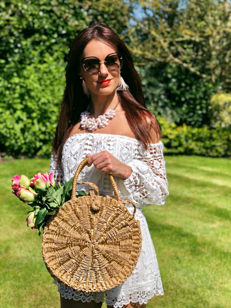 South Beach Round Gold Woven Straw Cross Body Bag | Miu Miu sunglasses | Elegant Duchess Boutique feather earrings | Glamorous Pearl Embellished Satin Sandals | Parisian Off Shoulder Crochet Playsuit | Accessorize statement necklace