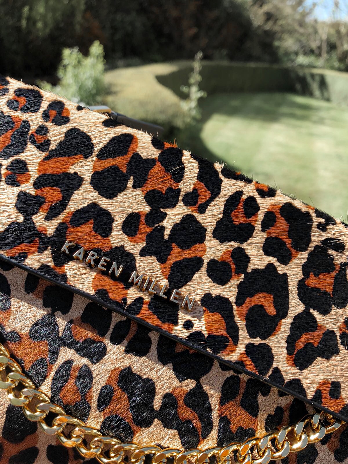 Elegant Duchess Fashion and Lifestyle Karen Millen Leather Chain Zip Clutch Bag, Leopard Print | Miu Miu sunglasses | Karen Millen leather Shoes Leopard Print | River Island tassel earrings | Replay Luz Mid Rise Rinse Jean with Contrast Stitch | Next Neutral Skinny Animal Print Belt