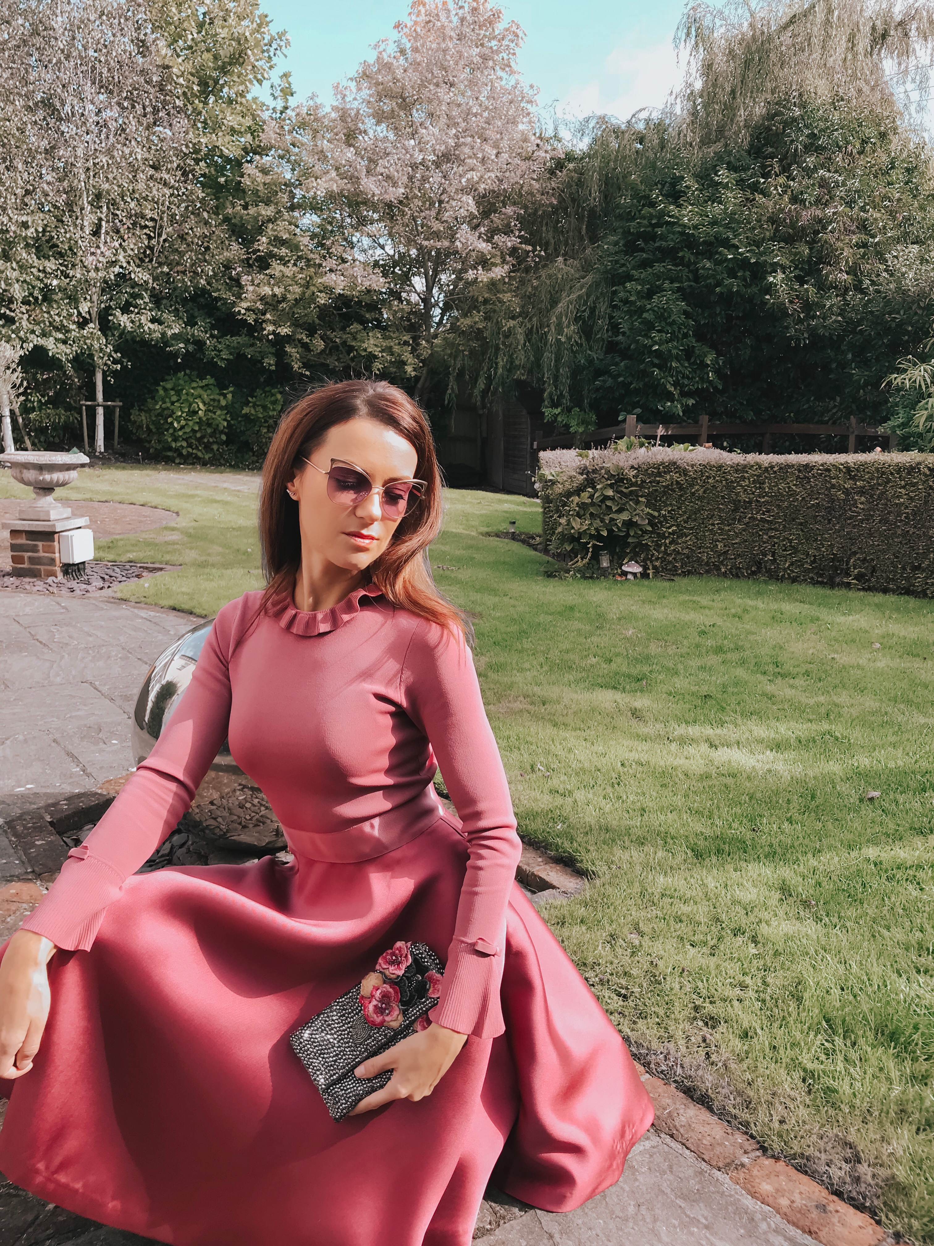 Elegant Duchess Fashion Ted Baker Pink Zadi Skater Dress | Kurt Geiger London Barbican-Wine-(Fabric) Knit Ankle Boot | Miu Miu Sunglasses | Swarovski earrings | Accessorize clutch bag